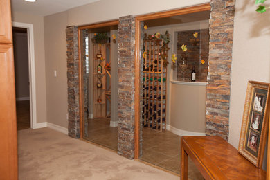Inspiration for a large traditional wine cellar in Denver with storage racks and brown floor.