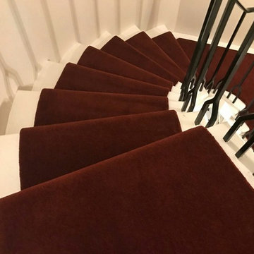 Red runner on a beautiful spiral staircase