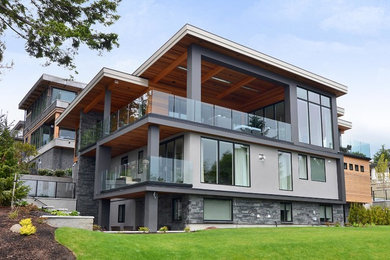 Huge minimalist gray three-story mixed siding exterior home photo in Vancouver
