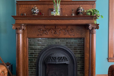 Example of a mid-sized ornate enclosed dark wood floor, brown floor and wainscoting family room design with a standard fireplace and a tile fireplace