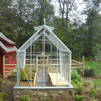 A greenhouse, barn and vegetable garden