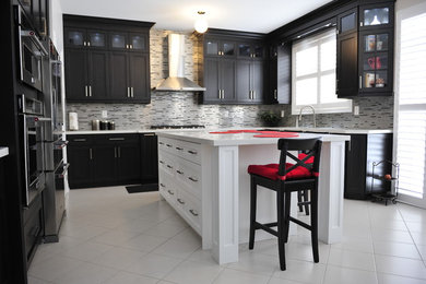 Mid-sized elegant l-shaped ceramic tile eat-in kitchen photo in Toronto with an undermount sink, shaker cabinets, dark wood cabinets, quartz countertops, metallic backsplash, matchstick tile backsplash, stainless steel appliances and an island
