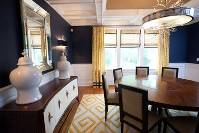 Enclosed dining room - large transitional medium tone wood floor enclosed dining room idea in New York with blue walls and no fireplace