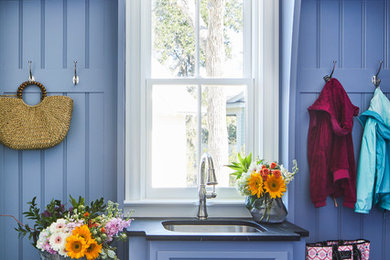 Mid-sized beach style porcelain tile and multicolored floor mudroom photo in Charleston with blue walls
