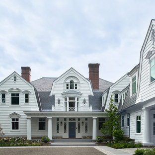 Inspiration for a cottage white two-story house exterior remodel in New York with a gambrel roof and a shingle roof