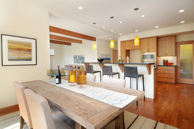 Example of a mid-sized trendy galley medium tone wood floor eat-in kitchen design in Seattle with flat-panel cabinets, medium tone wood cabinets and stainless steel appliances