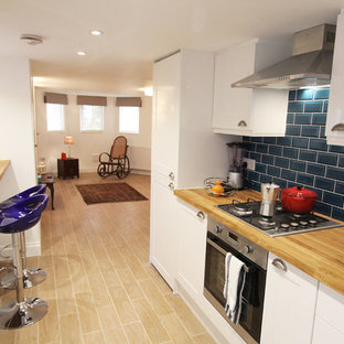 Small victorian look-out basement in London with white walls, ceramic flooring and no fireplace.
