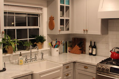 Open concept kitchen - small contemporary u-shaped medium tone wood floor open concept kitchen idea in San Diego with a farmhouse sink, shaker cabinets, gray cabinets, marble countertops, white backsplash, subway tile backsplash, stainless steel appliances and no island
