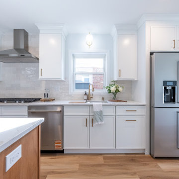 White Shaker Wall Cabinets with Gooseneck Faucet & Window View