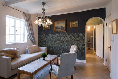 Example of a mid-sized eclectic formal and enclosed light wood floor living room design in Chicago with black walls, a wood stove, a stone fireplace and no tv