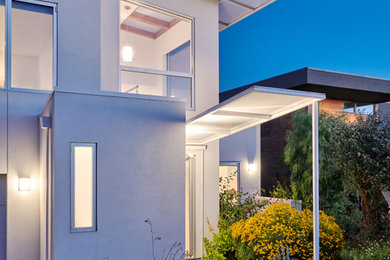 Inspiration for a mid-sized modern white three-story stucco exterior home remodel