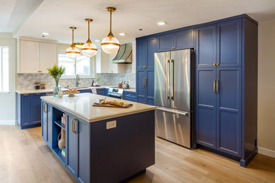 Inspiration for a mid-sized transitional l-shaped kitchen pantry remodel in San Francisco with quartz countertops, multicolored backsplash, stainless steel appliances, an island and blue countertops