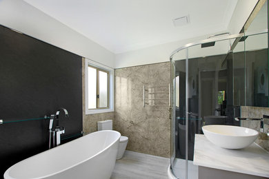 Inspiration for a large eclectic master bathroom in Wollongong with flat-panel cabinets, beige cabinets, a freestanding tub, a corner shower, a one-piece toilet, black walls, vinyl floors, a vessel sink, engineered quartz benchtops, grey floor, a sliding shower screen and white benchtops.