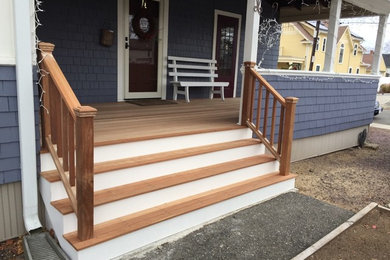 Mid-sized elegant front porch photo in Boston with decking and a roof extension