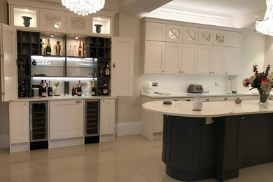 Photo of a large transitional eat-in kitchen in Surrey with an integrated sink, shaker cabinets, white cabinets, quartzite benchtops, mosaic tile splashback, stainless steel appliances and with island.