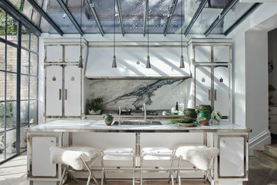 Design ideas for a large traditional galley kitchen in London with a submerged sink, white cabinets, marble splashback, integrated appliances, white worktops, recessed-panel cabinets, multi-coloured splashback, dark hardwood flooring, an island and brown floors.