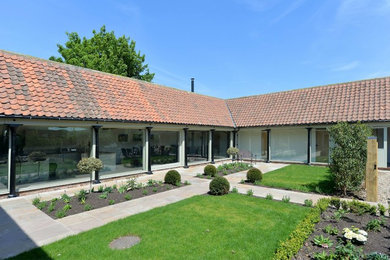 This is an example of a medium sized farmhouse house exterior in Other.