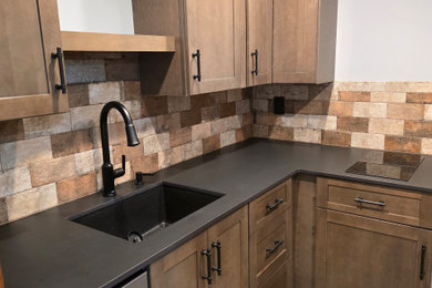 Inspiration for a small craftsman l-shaped ceramic tile and gray floor enclosed kitchen remodel in New York with an undermount sink, shaker cabinets, medium tone wood cabinets, quartz countertops, orange backsplash, cement tile backsplash, stainless steel appliances, no island and black countertops
