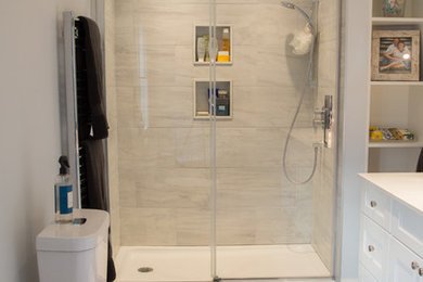Large trendy 3/4 beige tile and porcelain tile porcelain tile alcove shower photo in Toronto with shaker cabinets, white cabinets, a two-piece toilet, blue walls, an undermount sink and quartz countertops