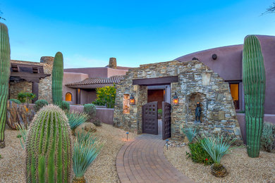 Inspiration for a large southwestern entryway remodel in Other with a brown front door