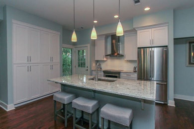 Beach style eat-in kitchen in Atlanta with an undermount sink, recessed-panel cabinets, granite benchtops, stainless steel appliances and with island.