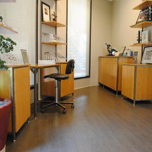 Medium sized modern home office and library in Phoenix with beige walls, cork flooring, no fireplace and a freestanding desk.