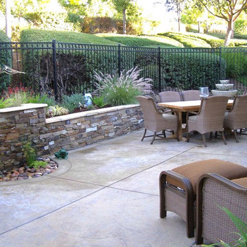Evergreen Villages- stained concrete patio and seat wall with stone veneer