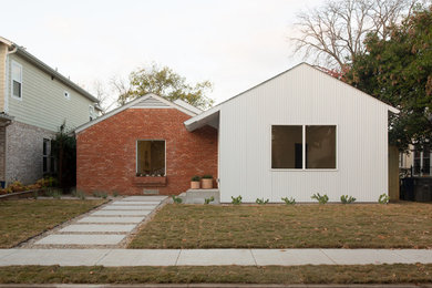 Example of a small minimalist white one-story metal exterior home design in Dallas with a shingle roof and a black roof