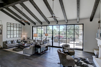 Inspiration for a large transitional open concept medium tone wood floor family room remodel in Phoenix with white walls, a two-sided fireplace, a stone fireplace and a media wall