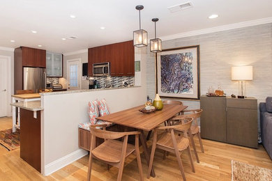 Inspiration for a small 1960s light wood floor and brown floor great room remodel in New York with gray walls