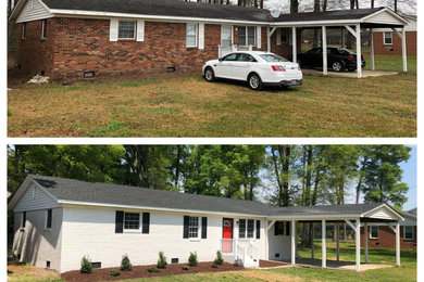 Mid-sized traditional white one-story brick house exterior idea in Other with a shingle roof and a black roof