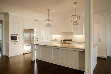 Eat-in kitchen - huge transitional u-shaped eat-in kitchen idea in Toronto with a double-bowl sink, shaker cabinets, white cabinets, granite countertops, white backsplash, subway tile backsplash, stainless steel appliances, an island and multicolored countertops