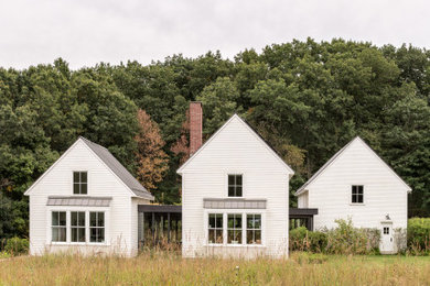 Country two-story wood and clapboard gable roof photo in Boston with a metal roof