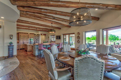 Great room - huge southwestern medium tone wood floor and brown floor great room idea in Phoenix with beige walls and no fireplace