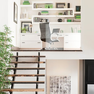 Design ideas for a medium sized modern study in Minneapolis with white walls, a built-in desk, dark hardwood flooring, no fireplace and brown floors.