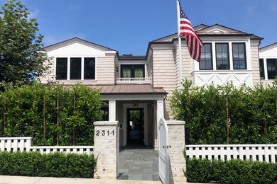 Inspiration for a three-story wood and shingle exterior home remodel in Los Angeles with a mixed material roof