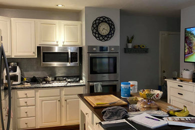 Example of a large eat-in kitchen design in St Louis with an island