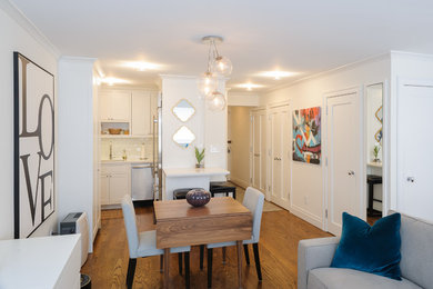 Great room - small traditional medium tone wood floor great room idea in New York with white walls and no fireplace