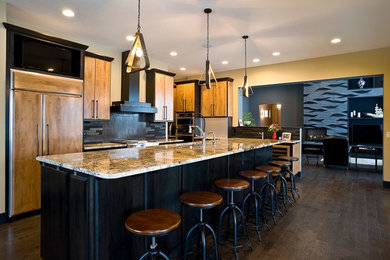 Enclosed kitchen - large contemporary l-shaped dark wood floor enclosed kitchen idea in Other with paneled appliances, an undermount sink, flat-panel cabinets, medium tone wood cabinets, granite countertops, black backsplash, stone tile backsplash and an island