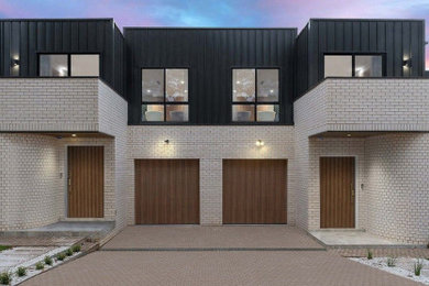 Design ideas for a large modern two-storey white duplex exterior in Sydney with mixed siding, a flat roof, a metal roof and a white roof.