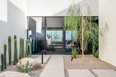 Design ideas for a mid-sized modern drought-tolerant, desert and partial sun side yard concrete paver landscaping in Other.