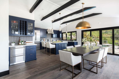 Design ideas for a transitional open plan dining in Los Angeles with white walls, dark hardwood floors and brown floor.