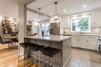 Mid-sized transitional l-shaped porcelain tile and gray floor eat-in kitchen photo in Other with an undermount sink, flat-panel cabinets, gray cabinets, quartz countertops, multicolored backsplash, matchstick tile backsplash, stainless steel appliances and an island