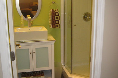 Corner shower - contemporary white tile and ceramic tile corner shower idea in Other with a vessel sink, white cabinets, glass countertops and a two-piece toilet