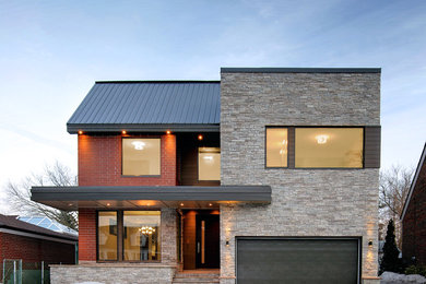 Inspiration for a large contemporary two-storey red exterior in Toronto with mixed siding and a flat roof.
