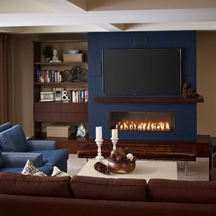 This is an example of a large classic walk-out basement in Toronto with beige walls, carpet, a ribbon fireplace, a plastered fireplace surround and beige floors.