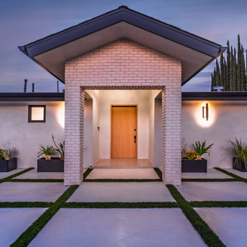 Lit Entry Portico Framing the Oak Door at Night