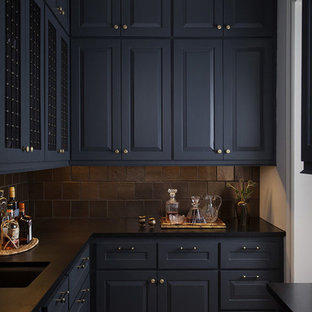 Mid-sized transitional kitchen pantry designs - Kitchen pantry - mid-sized transitional galley light wood floor and brown floor kitchen pantry idea in Austin with an undermount sink, raised-panel cabinets, black cabinets, soapstone countertops, black backsplash, porcelain backsplash, no island and black countertops