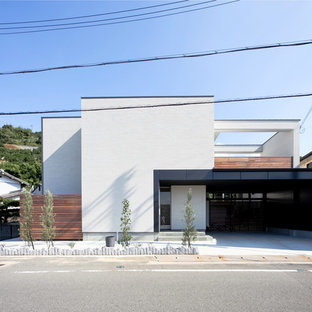 他の地域のモダンスタイルのおしゃれな二階建ての家 (レンガサイディング、マルチカラーの外壁、陸屋根、戸建) の写真