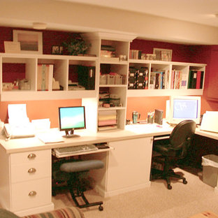 Photo of a large traditional home office in Chicago with red walls, a built-in desk, carpet, no fireplace and beige floor.